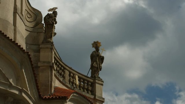 Saints with halo statues and a cloudy sky