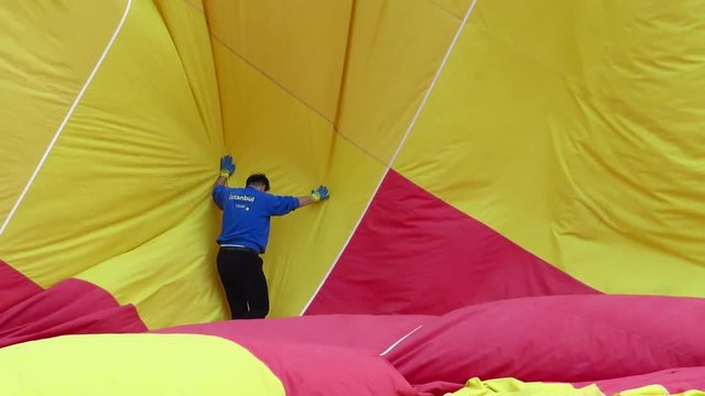 Man Deflating a Hot Air Balloon
