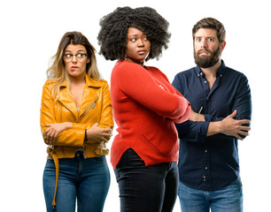 Group of three young men and women nervous and scared biting lips looking camera with impatient expression, pensive