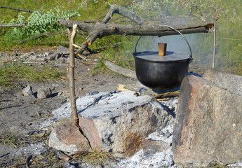 Cooking food in a bowler hat in the open air