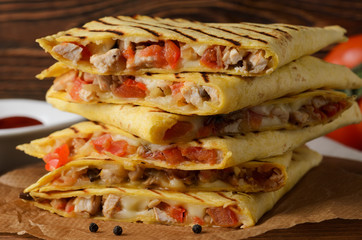 Quesadilla with chicken and tomatoes, close up.