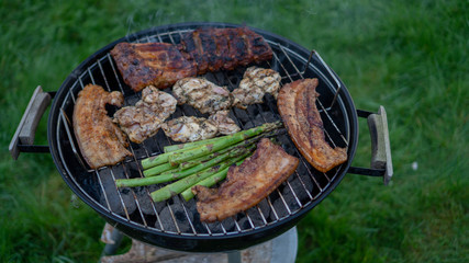 Barbecue Grill - Grilled chicken , Pork, spare ribs, sausage and vegetables asparagus on the Grill