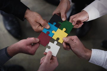 Teamwork of partners. Concept of integration and startup with puzzle pieces