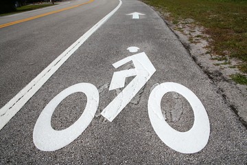 Bike Lane Symbol with Arrow Next to the Road in a Sunny Afternoon at Trade Winds Park, Pompano...