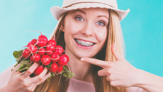 Happy woman holding radish