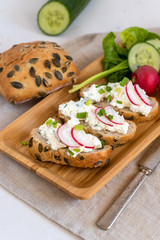 Light healthy sandwiches with soft cheese, radish and chives