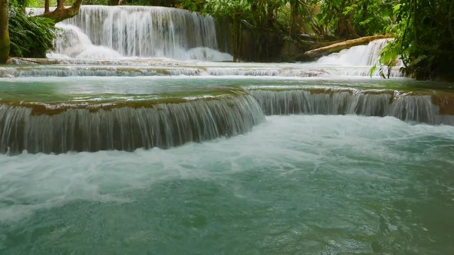 Paradise-like rain forest landscape with one of southeast Asia&rsquo;s most beautiful waterfalls, the Kuang Si falls with cascading natural swimming pools. Gimbel-stabilized 4k pan footage.