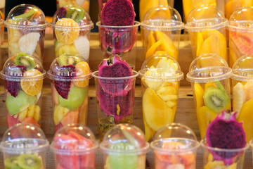 Fruits in the plastic cup for mix as juice - soft focus