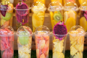 Fruits in the plastic cup for mix as juice - soft focus