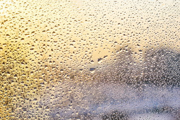Rain drops and frozen water on window glass background