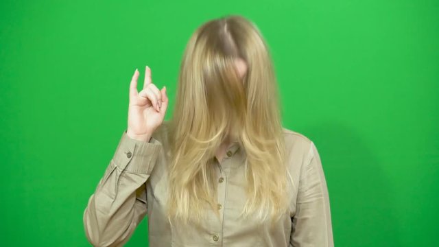 Young girl posing. Good mood. Performs arbitrary rhythmic movements to music. Background green screen.