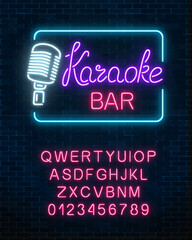 Neon signboard of karaoke music bar with alphabet. Glowing street sign of a nightclub with live music.