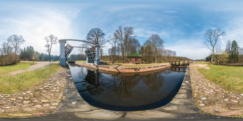 panorama 360 angle view near gateway lock construction on river, canal for passing vessels at...