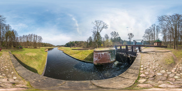 panorama 360 angle view near gateway lock sluice construction on river, canal for passing vessels at different water levels. Full spherical 360 degrees seamless panorama in equirectangular projection
