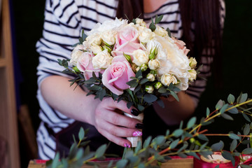 Florist makes bouquet for wedding.