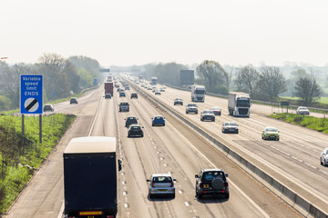 Sunny day view of UK motorway traffic - obrazy, fototapety, plakaty