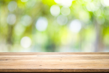 Wooden table with blur background of nature forest.