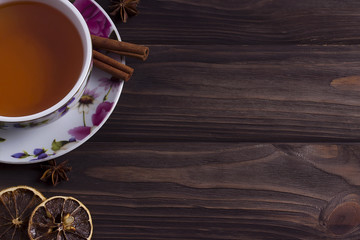 Teapot tea cup on brown wooden table.