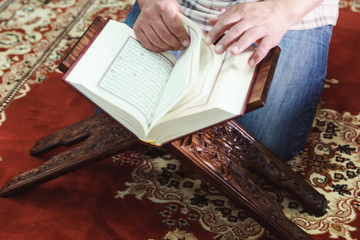 Muslim man reading Islamic holy book quran