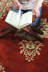 Muslim man reading Islamic holy book quran