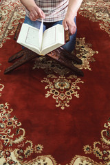 Muslim man reading Islamic holy book quran