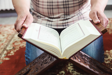 Muslim man reading Islamic holy book quran