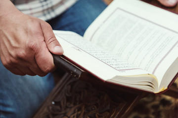 Muslim man reading Islamic holy book quran