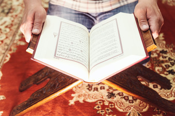 Muslim man reading Islamic holy book quran