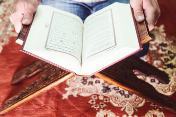 Muslim man reading Islamic holy book quran