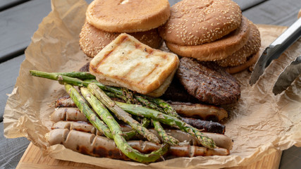 Hamburger Set. The person is going to grill beef patties, sausages, grilled cheese and asparagus