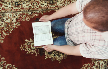 Muslim man reading Islamic holy book quran