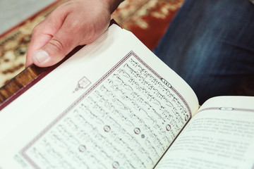 Muslim man reading Islamic holy book quran