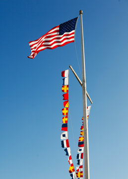 Vawing American flag against clear sky during daytime