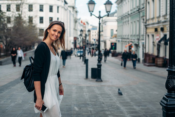 Travel in Europe. Girl is walking along the old street. Traveler walks in Moscow
