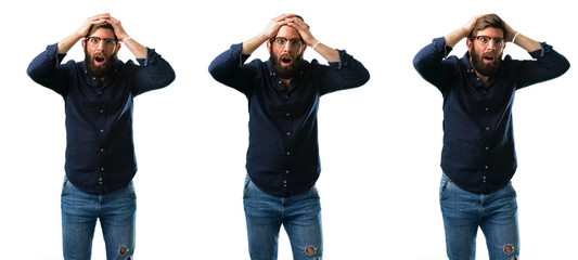 Young man with beard stressful keeping hands on head, terrified in panic, shouting isolated over white background