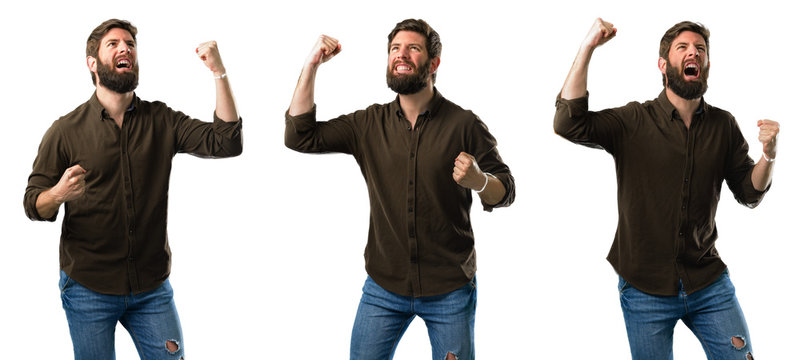 Young man with beard happy and excited celebrating victory expressing big success, power, energy and positive emotions. Celebrates new job joyful isolated over white background