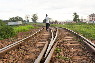 Lugazi, Uganda. 17 May 2017. A railway track in rural Uganda. A man walking along it.