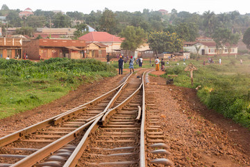 Fototapeta na wymiar Lugazi, Uganda. 17 May 2017. A railway track in rural Uganda. People are walking along and across it.
