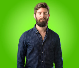 Obraz premium Young hipster man with big beard confident and happy with a big natural smile looking side over green background