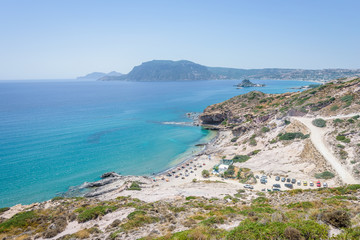 Beautiful sunny coast view to the greek mediterranean blue sea with crystal clear water and pure...