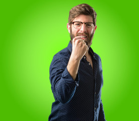 Young hipster man with big beard happy and excited expressing winning gesture. Successful and celebrating victory, triumphant over green background