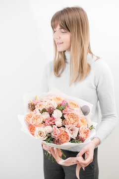 bouquet of beautiful flowers in women's hands. Floristry concept. Spring colors. the work of the florist at a flower shop. Vertical photo