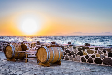 Beautiful sunset sunrise moody coast view to the warm colored aegean blue sea with big waves to...