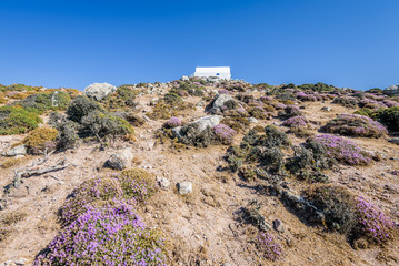 Holy greek white blue chruch chapel of agios Ilias shining above a greek island over the...
