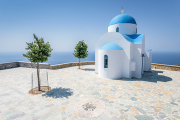 Holy greek white blue chruch chapel of agios theologos sant john shining above the village Nikia...