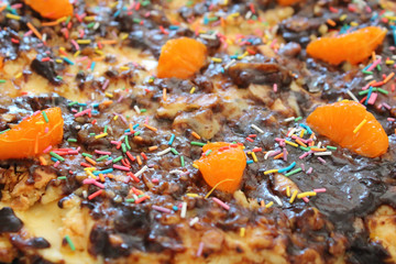 Beautiful puff cake covered with chocolate. Handmade cake on a plate on the table. Close-up.
