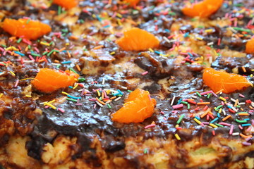 Beautiful puff cake covered with chocolate. Handmade cake on a plate on the table. Close-up.