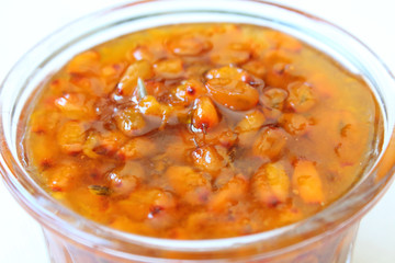 Fresh sea-buckthorn jam in a glass bowl. Close-up.