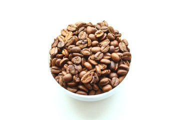 Coffee natural roasted in arabica beans in a bowl. Isolated on white background. Close-up.