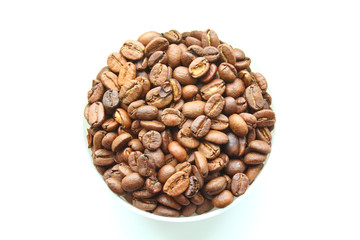 Coffee natural roasted in arabica beans in a bowl. Isolated on white background. Close-up.